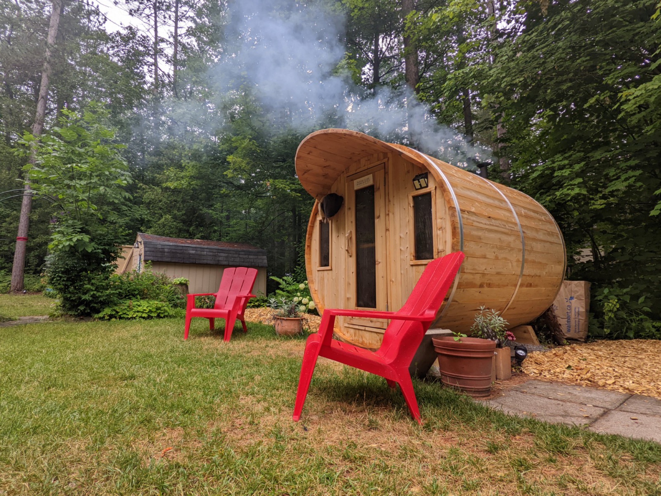 Wood sauna with red chairs in the Calwaja grounds